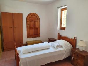 a bedroom with a bed with two pillows on it at Stoupa Mani Tower in Stoupa