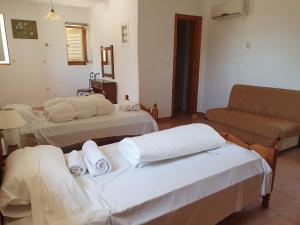 A bed or beds in a room at Stoupa Mani Tower