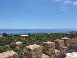 a view of the ocean from the ruins of a building at Stoupa Mani Tower in Stoupa