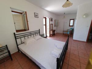 A bed or beds in a room at Stoupa Mani Tower