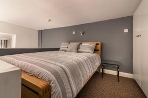 a bedroom with a large bed with a wooden headboard at PLATFORM City Studio with Parking in Hull