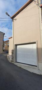 a large white garage door on the side of a building at Casa da Xastra in Vimianzo
