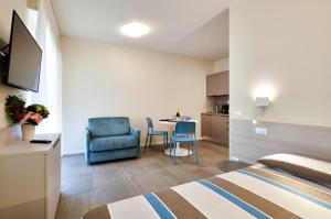 a hotel room with a bed and a table and a chair at Pegaso Civico2 in Garda