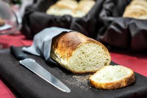 a loaf of bread on a black plate with a knife at Hotel Varese in Rome +30 photos