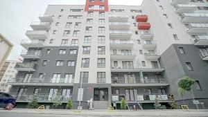 ein großes Apartmenthaus mit Balkon auf einer Straße in der Unterkunft Giorgia and Ary in Braşov