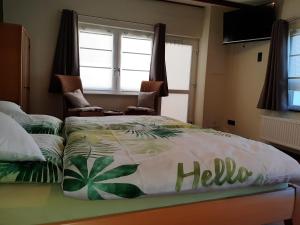 a bedroom with a bed with a hello blanket on it at Appartement Merl in Saarwellingen