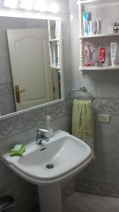 a bathroom with a white sink and a mirror at Los Cristianos Beach apartments in Los Cristianos