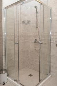 a shower with a glass enclosure in a bathroom at Aparthotel Primorsko in Primorsko