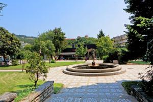 a fountain in the middle of a park at Orchideia Studios in Sandanski