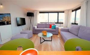 a living room with a couch and a table at L&acute;Aguila Suites - Turismo de Interior in Palma de Mallorca