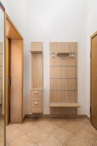 a closet with wooden shelves and a closet door at Apartment Ladislav in Linardići