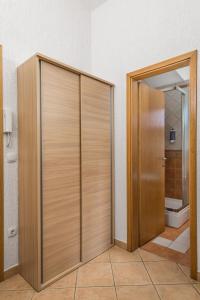 a wooden door in a bathroom with a toilet at Apartment Ladislav in Linardići +18 photos