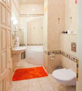 ein Badezimmer mit einer Badewanne, einem WC und einem Waschbecken in der Unterkunft Odessa Apartments Cherkasets in Odessa