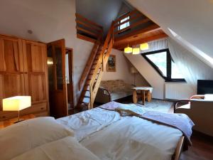 a bedroom with a bed and a stair case at Galicówka in Poronin +69 photos