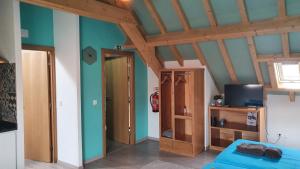 a living room with blue walls and wooden beams at GO4SURF beach Lofts in Peniche