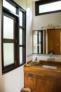 a bathroom with a wooden sink and a mirror at Risasinee Spa & Resort in Nan