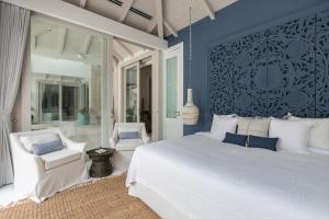 a bedroom with a white bed and blue walls at Mia Palm, beach villa and events in Bophut  +42 photos