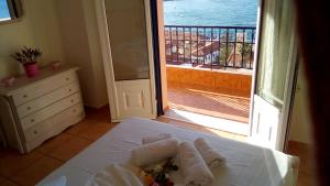 a room with a bed with a view of the ocean at Mairoula apartments! in Koroni