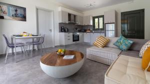 a living room with a couch and a table at Villa Esther in Kefallonia