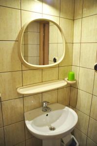 a bathroom with a sink and a mirror at Dom Wczasowy Dwa Światy in Bukowina Tatrzańska