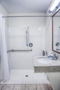 a white bathroom with a sink and a shower at Candlewood Suites Fargo-North Dakota State University, an IHG Hotel in Fargo