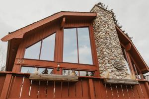 a house with a large window on the side of it at Ambleside Lodge Bed & Breakfast in Canmore