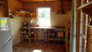 a kitchen with a counter and a window at Domek Majowy ze strefą Wellness in Susiec