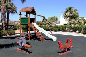 a playground with a slide and two chairs at Vila Mós in Lagos