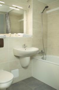 a bathroom with a sink and a toilet and a shower at Hotel les Tourrades in Cannes +32 photos