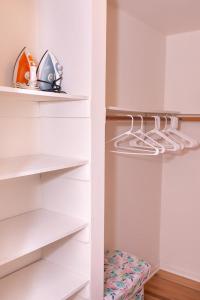 a white walk in closet with white shelves at SPECIAL RATE WORTHY POSH AND MAGNIFICENT 4 BEDROOMS AND TWO & HALF BATH in Greenbelt