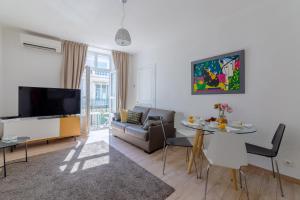 a living room with a couch and a table at Apartment on Dante street next to the sea in Nice