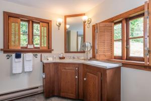 a bathroom with a sink and a mirror at Hastings House Country House Hotel in Ganges +98 photos
