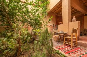 a patio with a table and chairs in a house at Dar Essalama Dades in Akhendachou nʼAït Ouffi