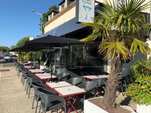 a row of tables and chairs outside of a restaurant at La Locomotive in Issoudun