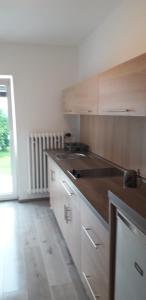 a kitchen with white cabinets and a wooden counter top at Království klidu in Prachatice