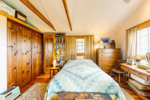 a bedroom with a bed and a desk at Sunset on the Vineyard in Vineyard Haven
