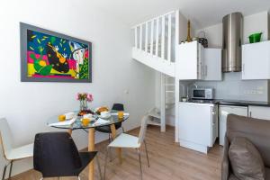 a kitchen and a dining room with a table and chairs at Apartment on Dante street next to the sea in Nice