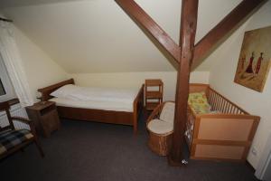 a small bedroom with a bed and a chair at Bernard Meyborg in Lindern