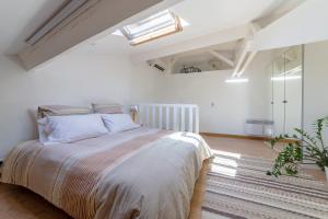 a bedroom with a large bed in a white room at Apartment on Dante street next to the sea in Nice