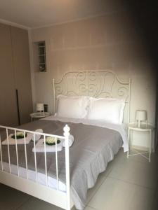 a bedroom with a white bed with white pillows at Maisonette Lux Modern Next to Metro Kerameikos 3 Rooms in Athens