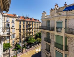 a view of a street in a city with buildings at Apartment on Dante street next to the sea in Nice