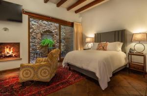 a bedroom with a bed and a fireplace at Hotel Boutique Casa Colorada in Pátzcuaro
