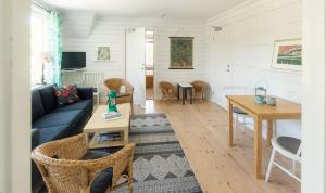 a living room with a couch and a table at Mejeriet Stenkyrka in Tingstäde