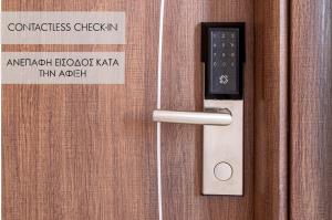 a door handle with a sign on a wooden door at BOUTiE Premium, a KalamataStay Property in Kalamata