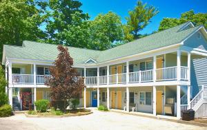 a large white house with a blue roof at Empire Lakeshore Inn in Empire