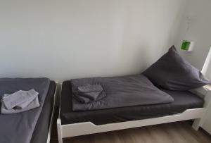 a bed in a room with two pillows on it at Ferienwohnung Strandjuwel am Strand in Norddeich