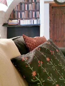a pile of pillows sitting on top of a couch at Quatre Chats sous un Pin in Le Thoureil