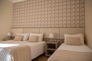 Postel nebo postele na pokoji v ubytování Hotel Pousada Kaster