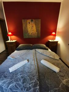 a bedroom with a bed with two pillows and two lamps at Apartments Volče in Tolmin