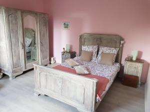 a bedroom with a bed and two dressers at Les Glycines in Gouvy